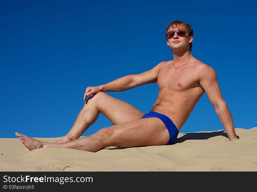 Young athletic man in the water with wearing sunglasses. Young athletic man in the water with wearing sunglasses.