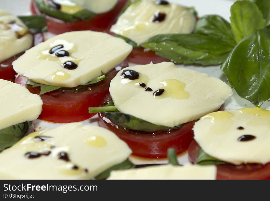 Tomatos, mozzarella and basil with olive oil.