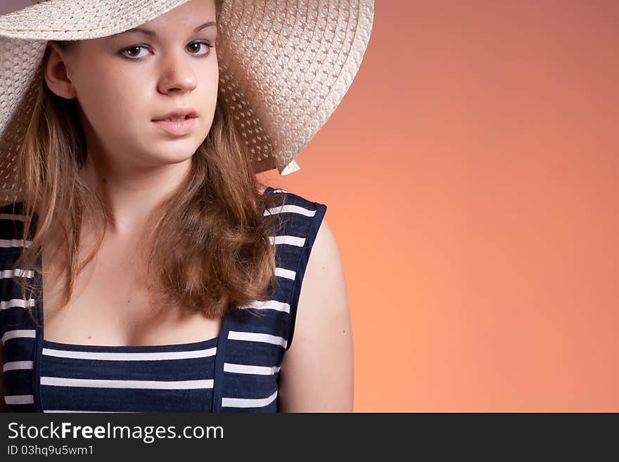 Portrait of a girl wearing a hat with a red background