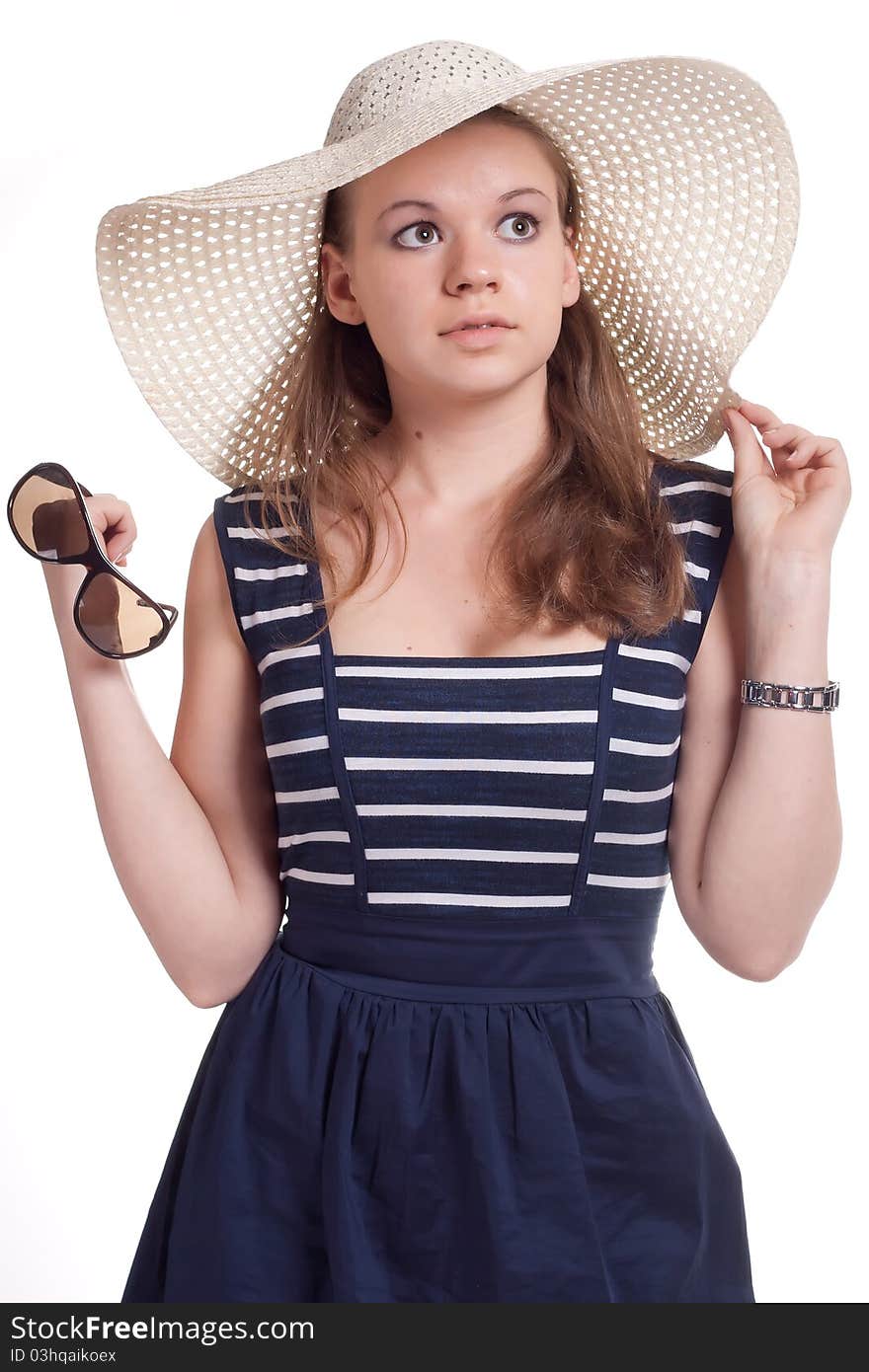 A girl in a straw hat with sunglasses in hand on white background