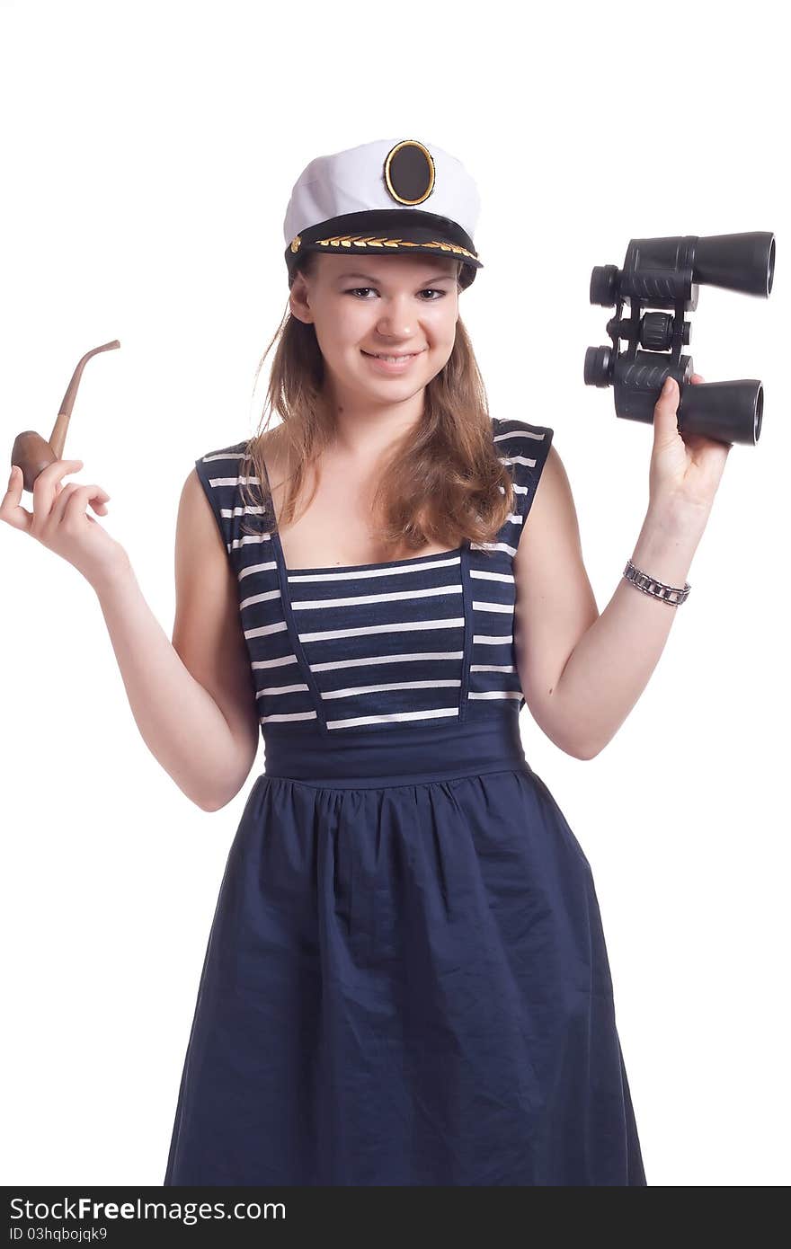 A girl in a sailor cap holding a pair of binoculars and a pipe for smoking on a white background