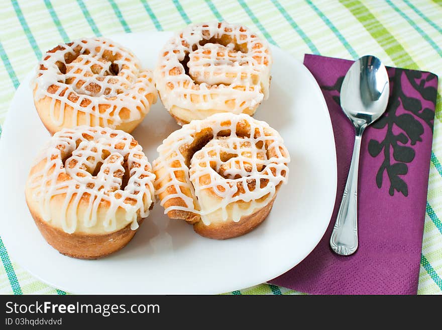 Four rolled muffins with cinnamon and glaze