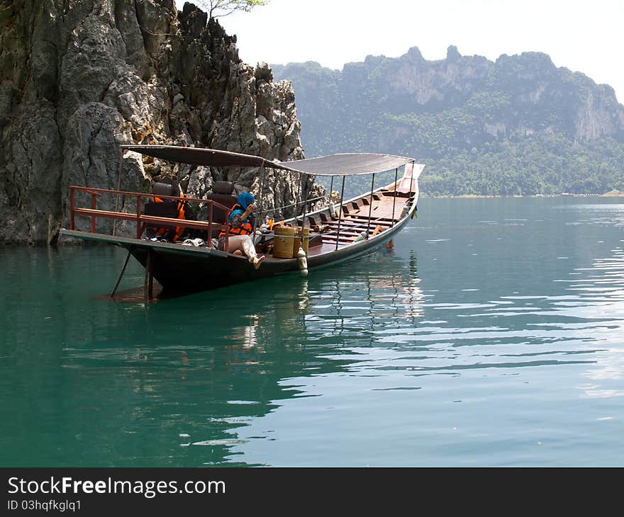 Woman On Boat And Ratchapapa Dam, Thailand