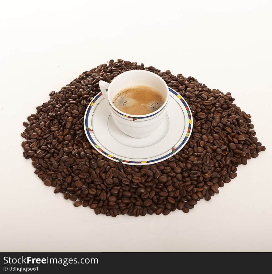 Coffe cup over coffee beans. Coffe cup over coffee beans