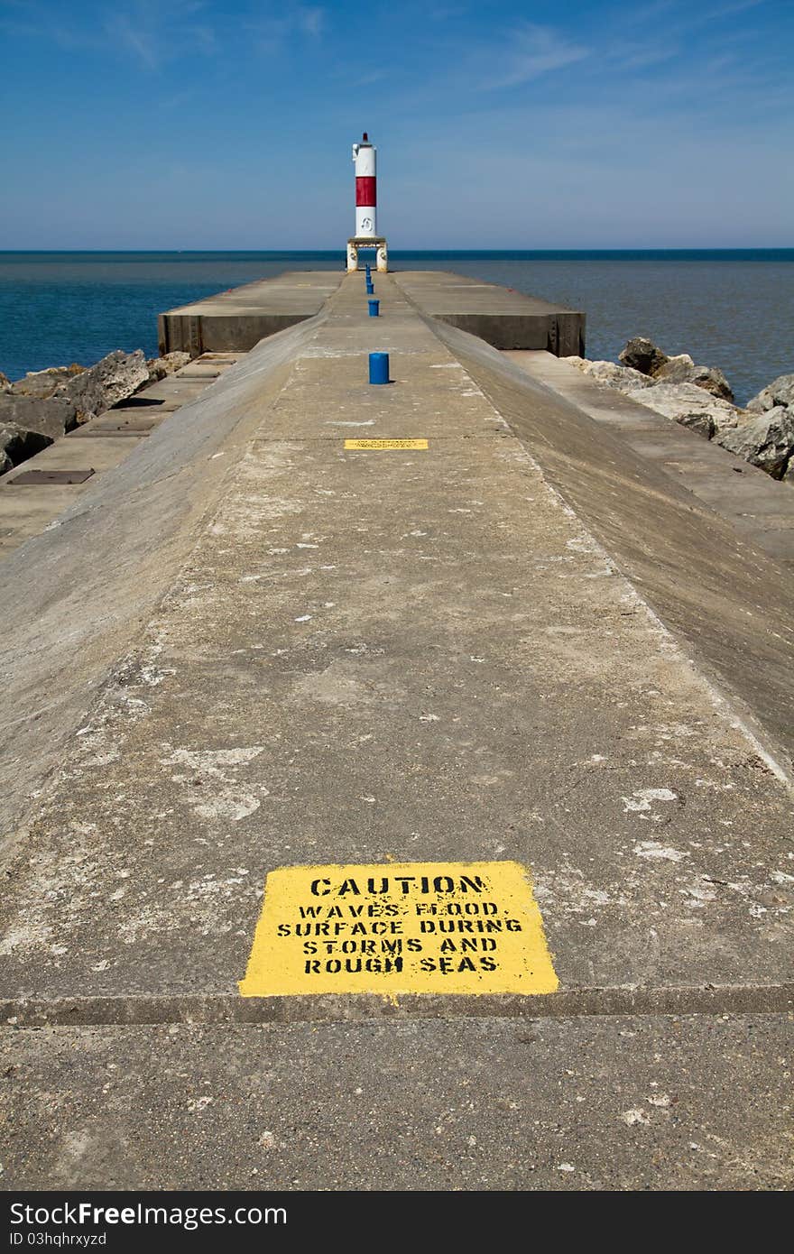 Caution sign on a cement pier. Caution sign on a cement pier