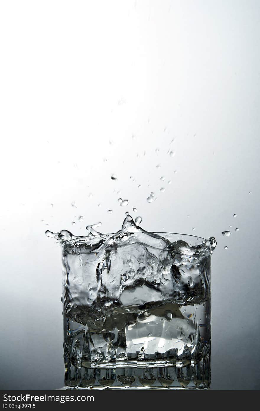 Water splash on glass over the graduated background