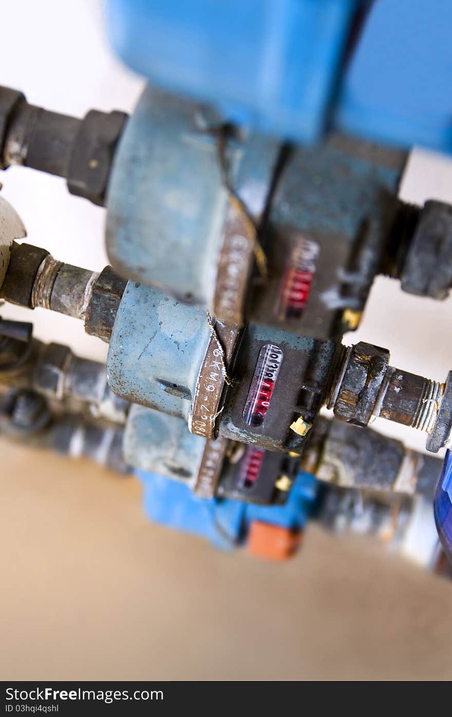 Top view of a row of weather beaten water meters in shallow depth of field. Top view of a row of weather beaten water meters in shallow depth of field.