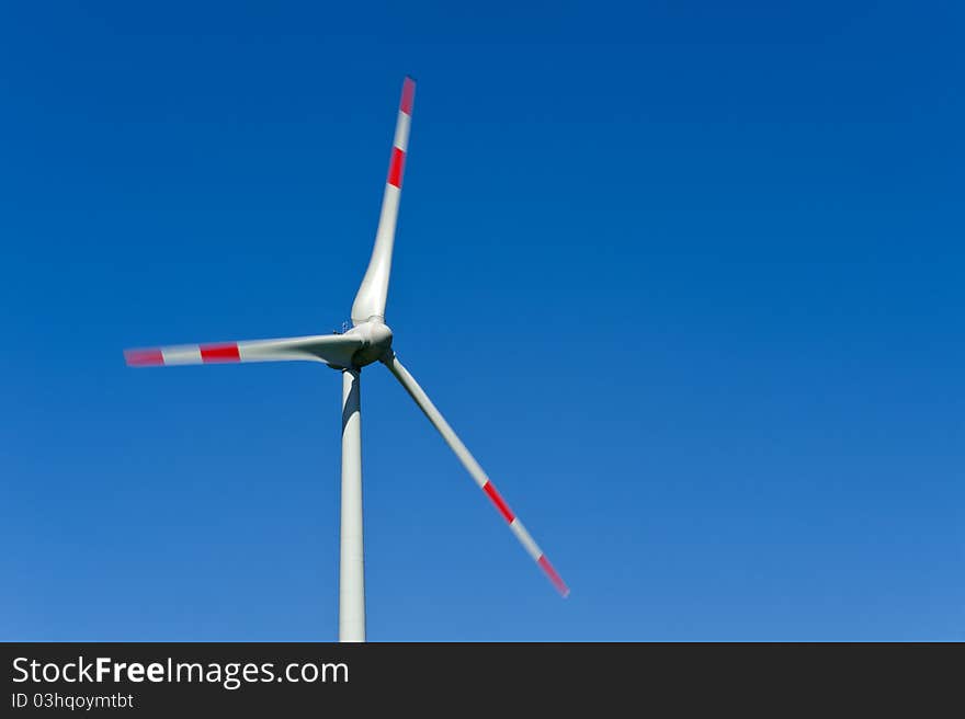 Wind turbine against a blue background