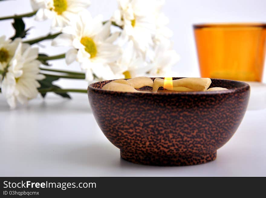 Simple white daisies and candles with isolated white background