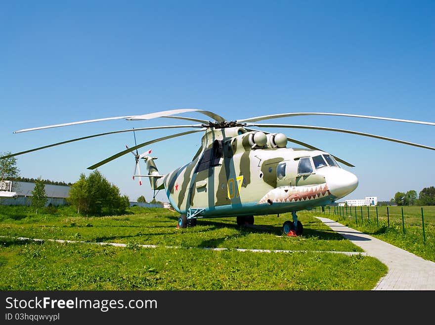 Large helicopter, green grass znd blue sky