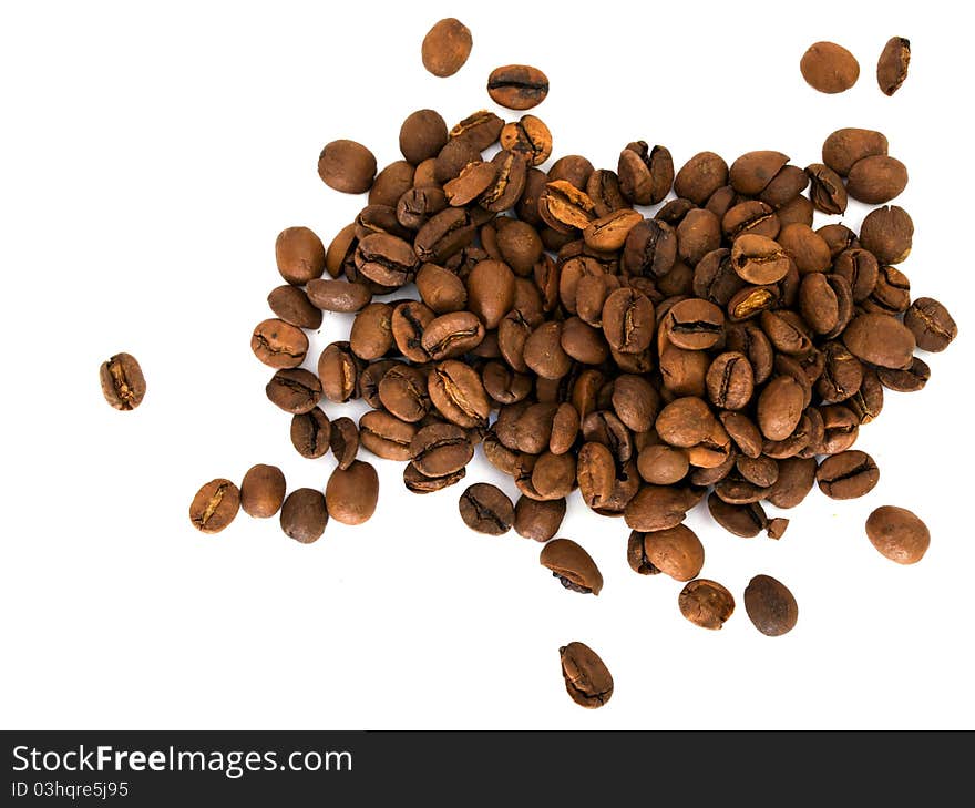 Scattered grains of black coffee isolated on white