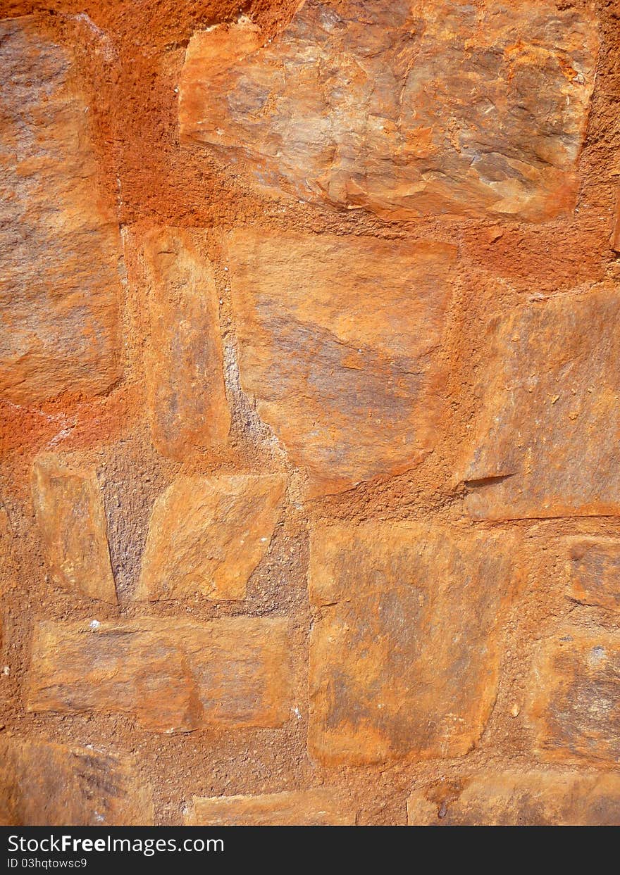 Stone wall in ginger tones on background format. Stone wall in ginger tones on background format