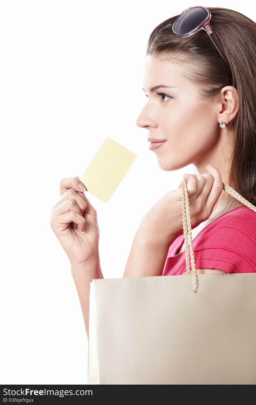 Attractive girl with shopping bags and credit card on a white background. Attractive girl with shopping bags and credit card on a white background