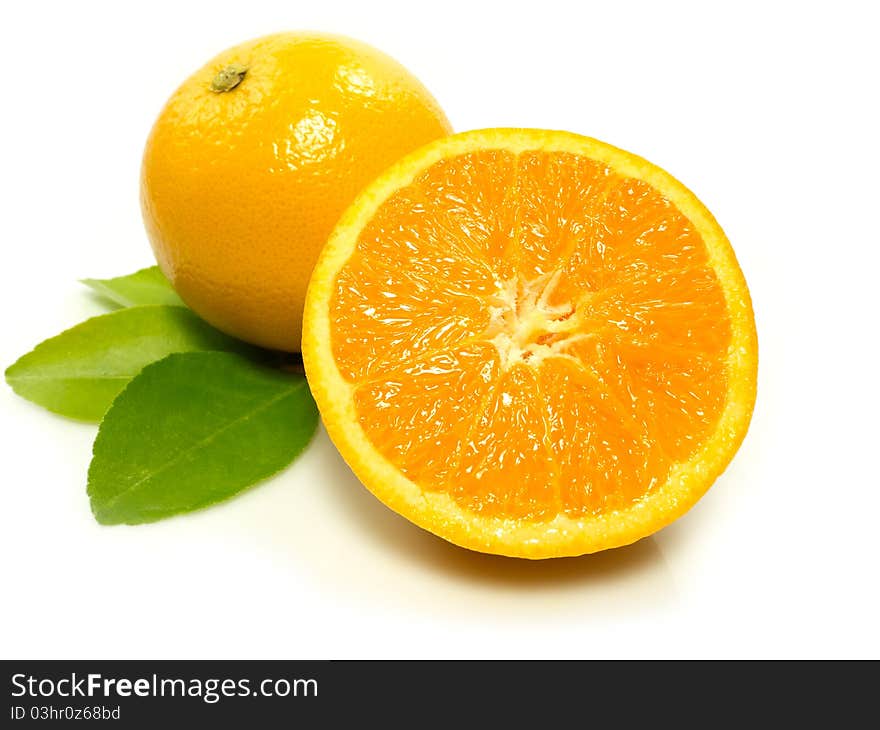 Oranges with leaves isolated on white background.