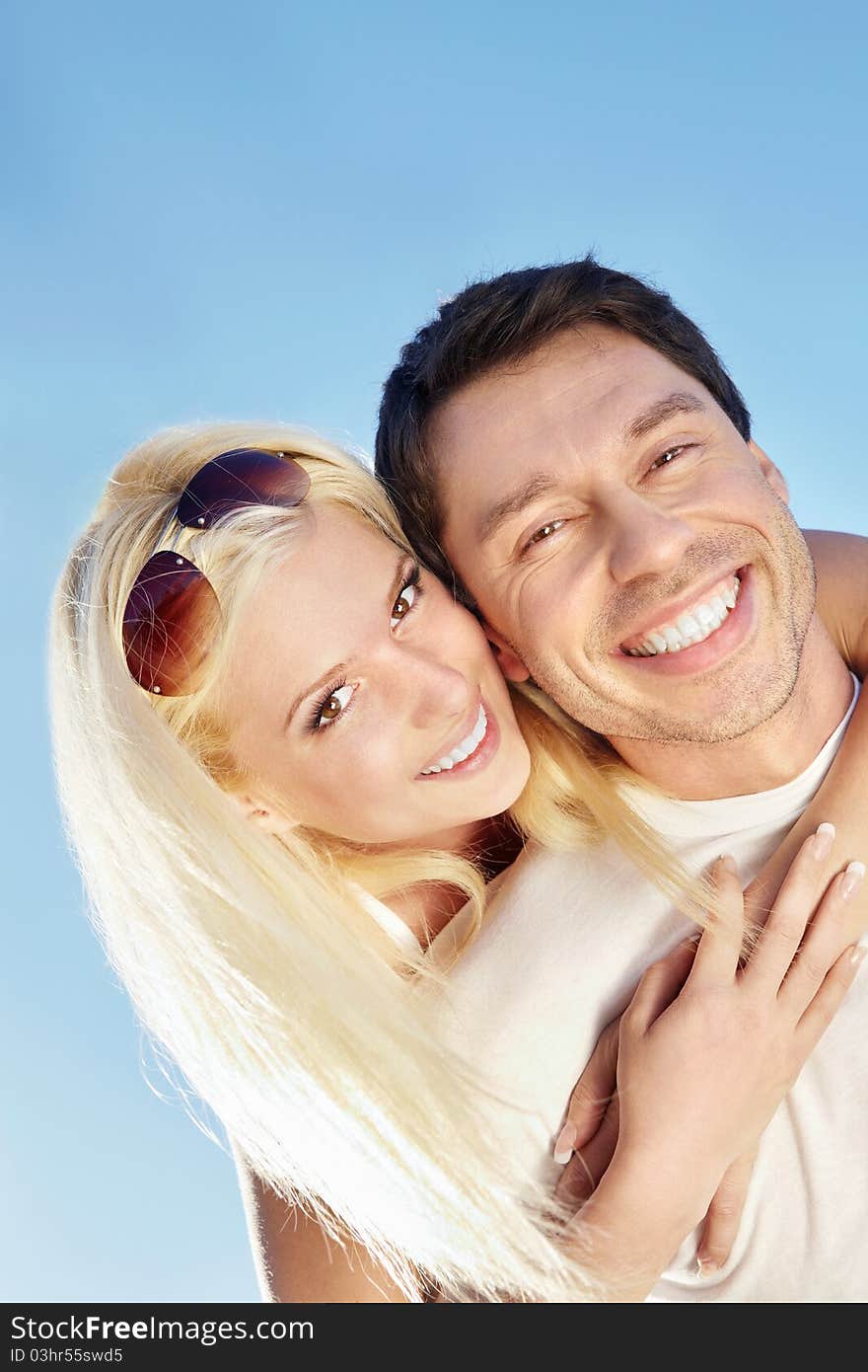 Attractive young couple against the sky. Attractive young couple against the sky