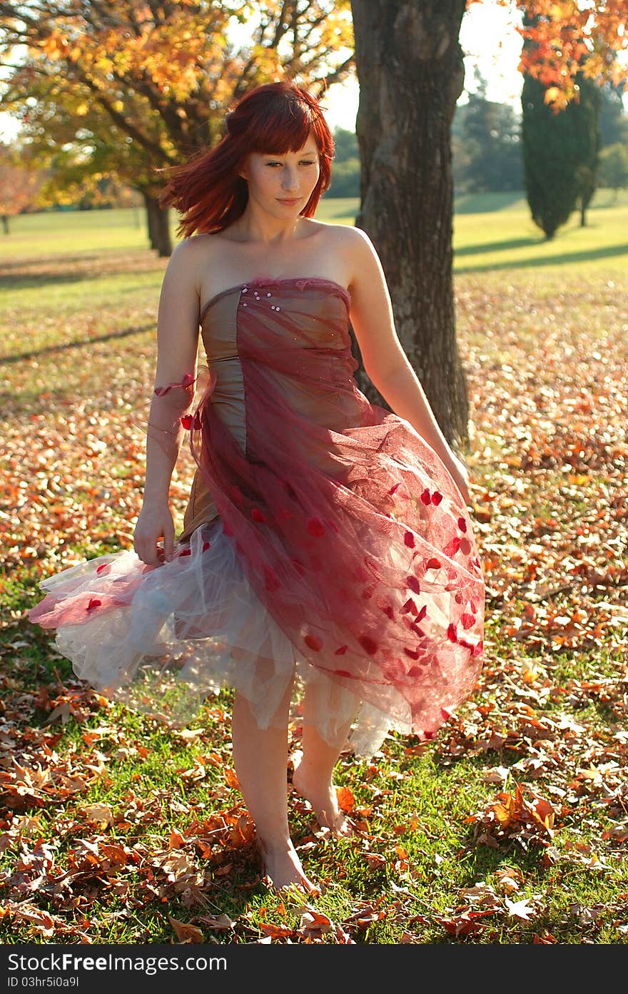 Girl enjoying a stroll in the park on a sunny autumn day. Girl enjoying a stroll in the park on a sunny autumn day