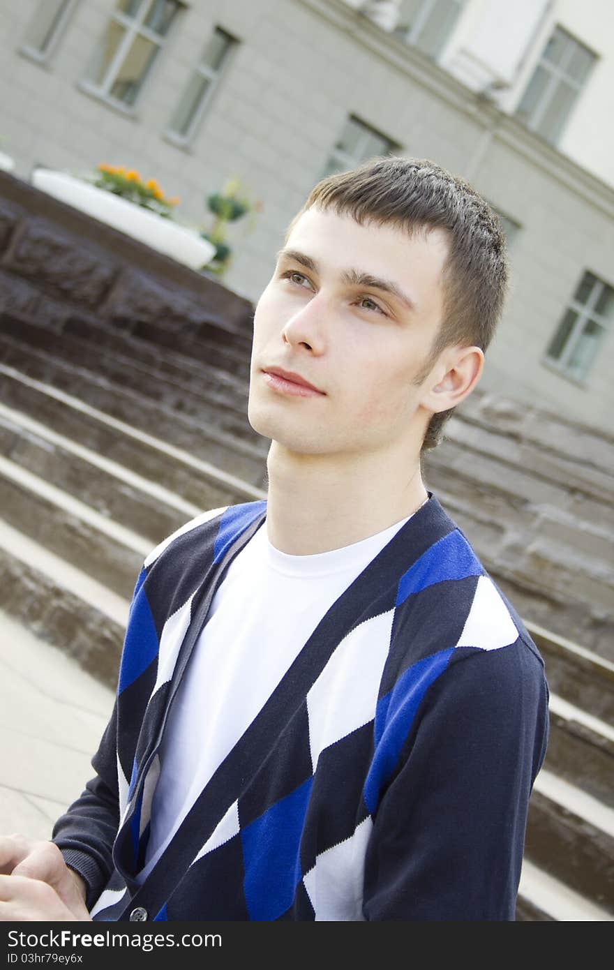 Attractive young male student on the campus of the University of smiles. Attractive young male student on the campus of the University of smiles