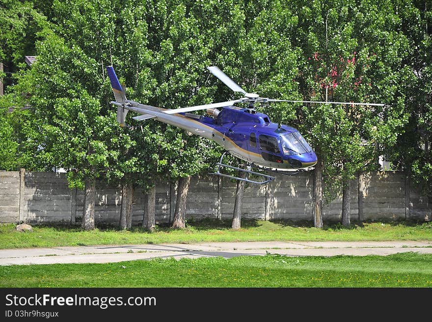 Helicopter departing from the field. Helicopter departing from the field