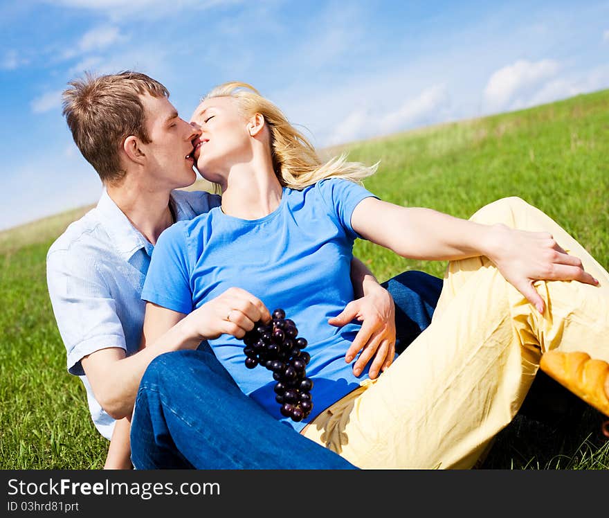 Happy young couple having a picnic outdoor on a summer day. Happy young couple having a picnic outdoor on a summer day