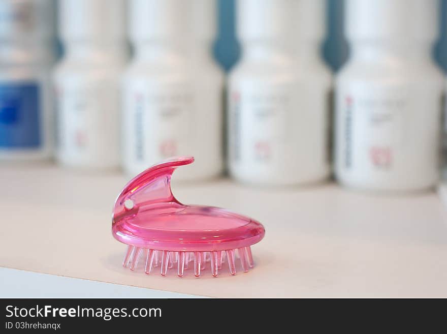 Comb on the background of cosmetics