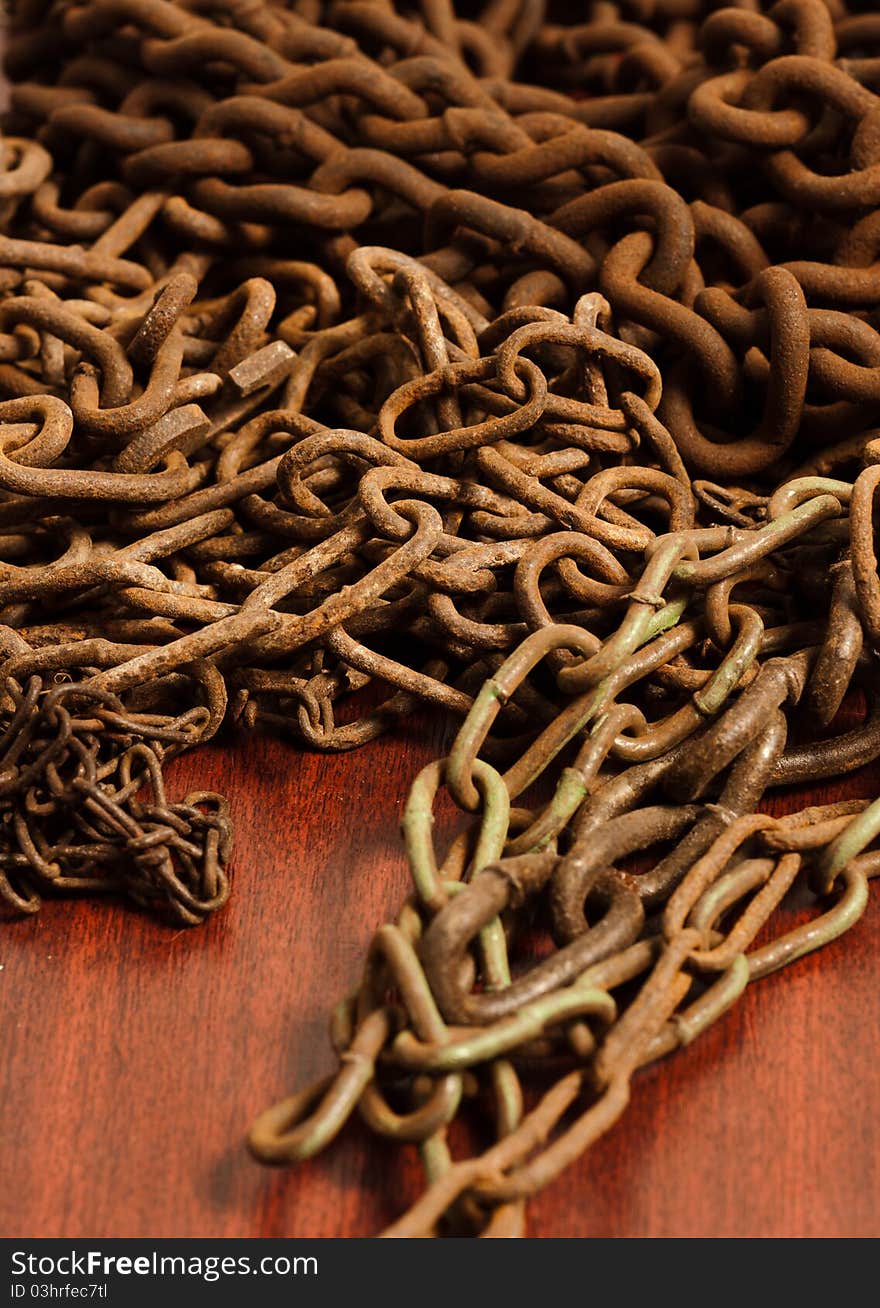 Rusty chain on wooden board