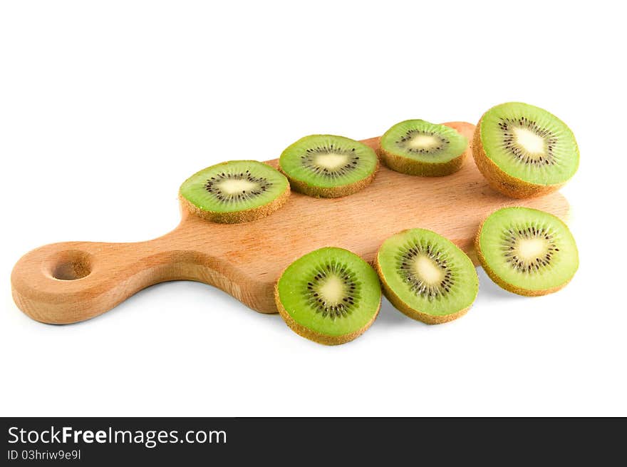 Slices of kiwi on the cutting board over white