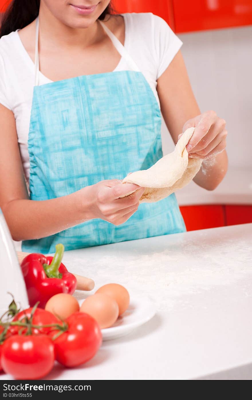 Woman hands mixing dough on the table