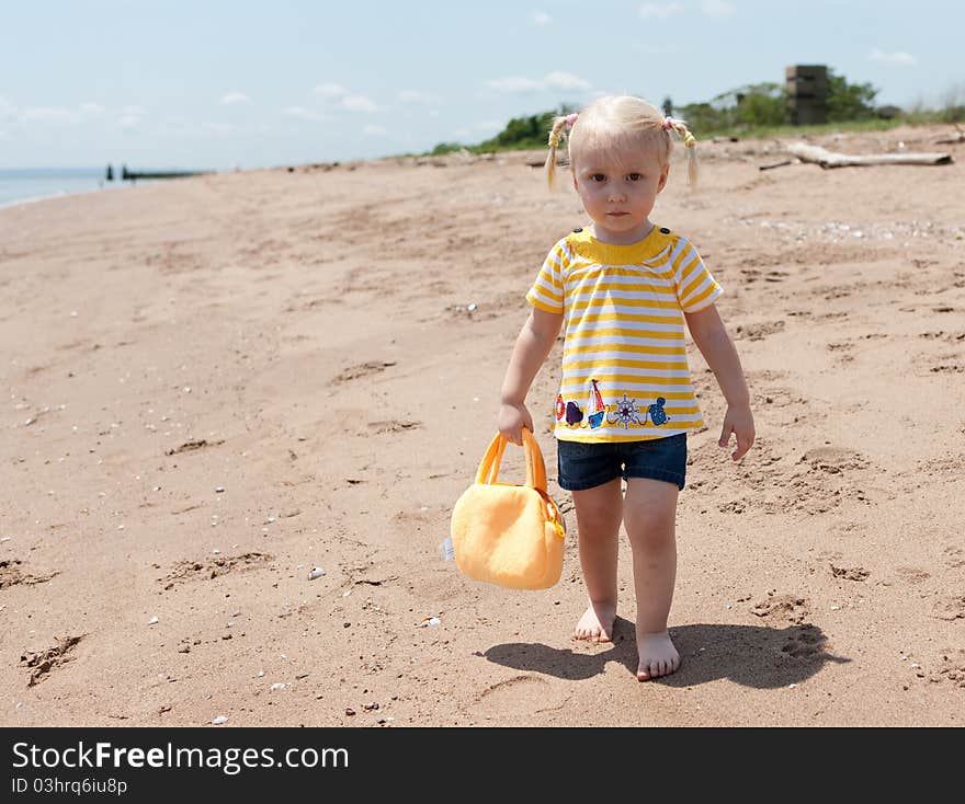 Image of the baby girl on the beach