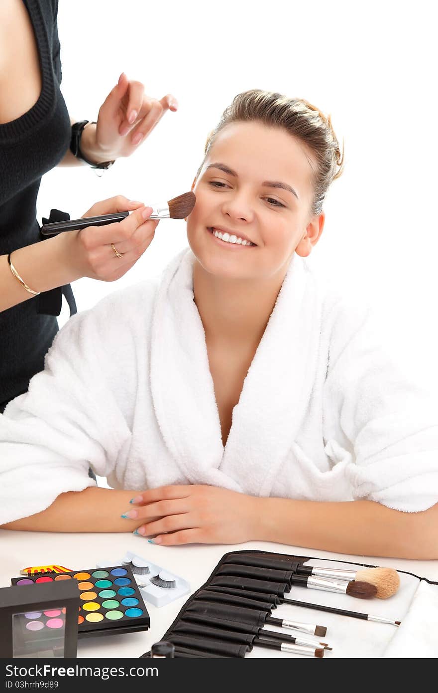 Cosmetician applying makeup to a lovely model. Cosmetician applying makeup to a lovely model