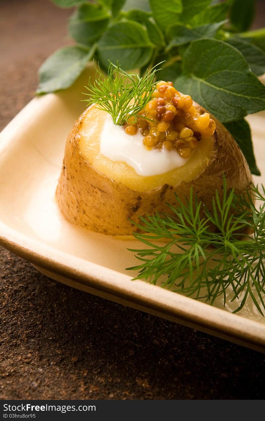 Baked potato with sour cream, mustard and herbs