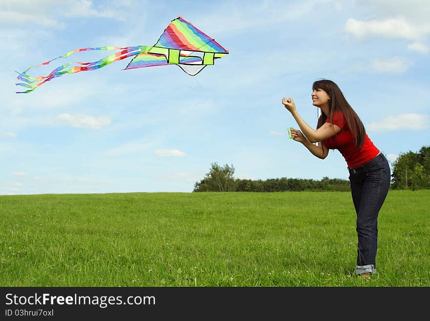 Young girl in red shirt flying kite on summer meadow. Young girl in red shirt flying kite on summer meadow