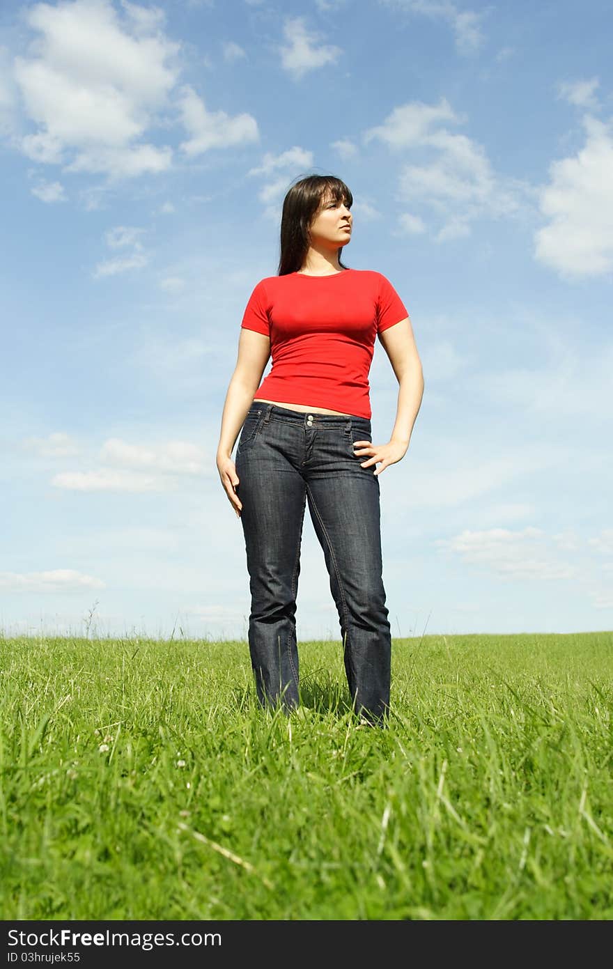 Girl standing on summer meadow