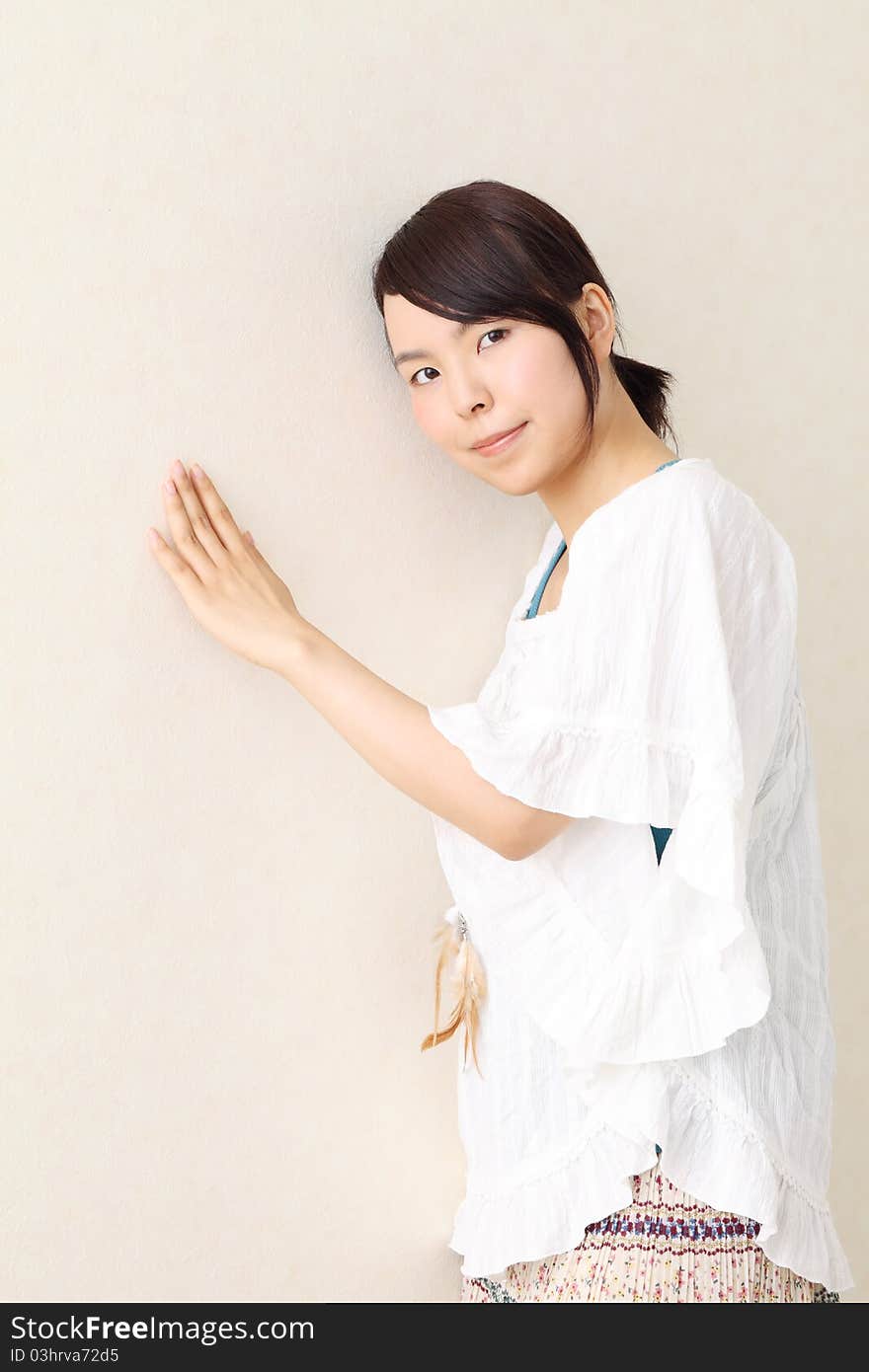 Beautiful young japanese woman leaning on the wall. Beautiful young japanese woman leaning on the wall