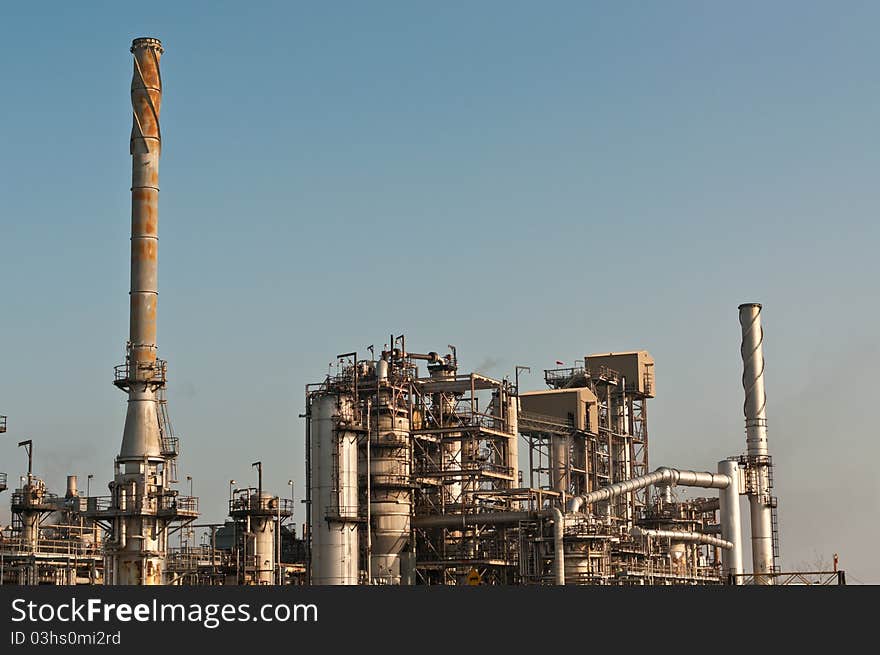 A petrochemical refinery plant with pipes and cooling towers.