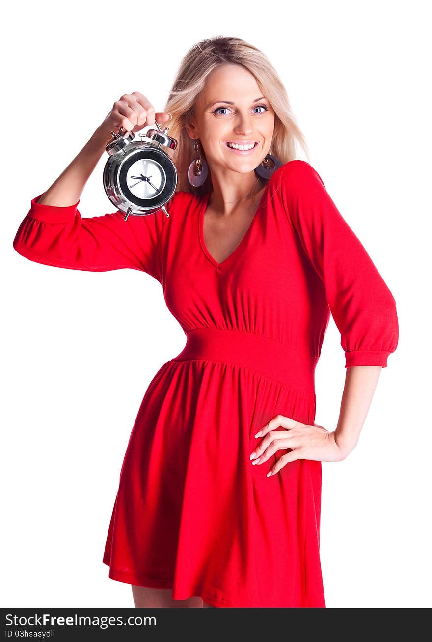 Beautiful happy young blond woman holding an alarm clock, isolated against white background. Beautiful happy young blond woman holding an alarm clock, isolated against white background