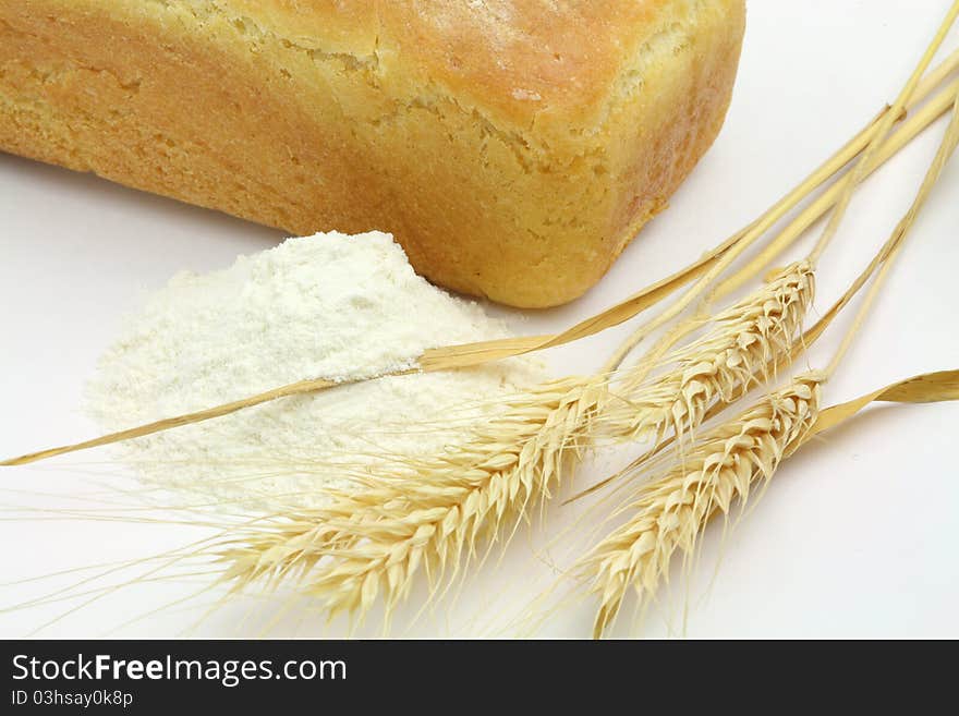 White Bread And Spikes Of Wheat And Wheat Flour on White