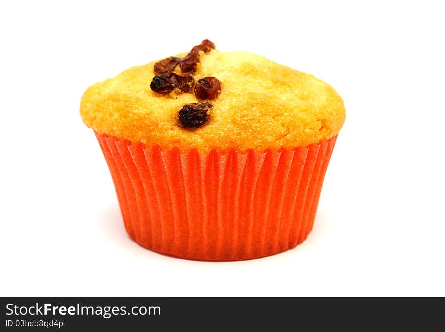 Tasty yellow muffin with many brown raisins