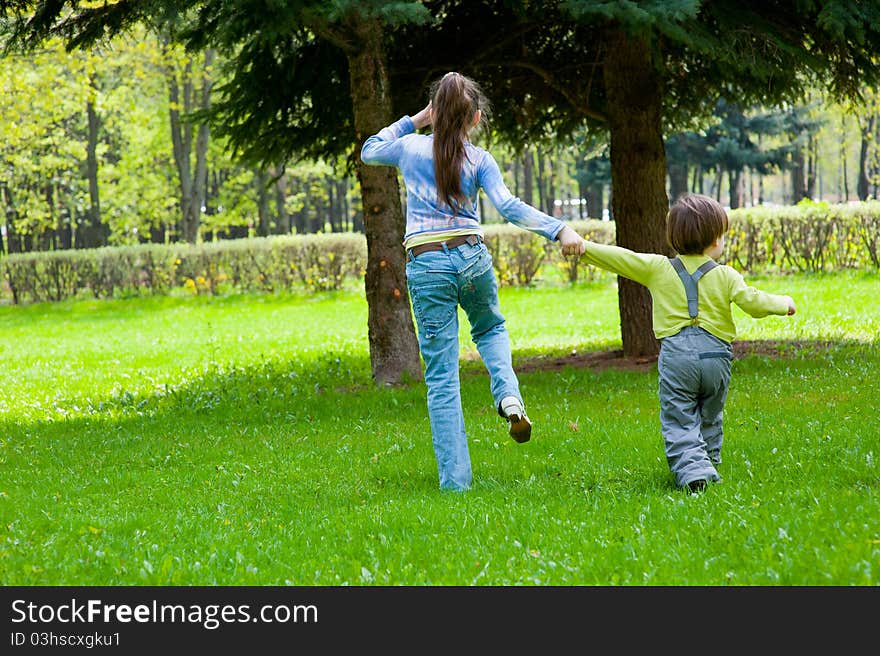 Brother and sister having fun in a park