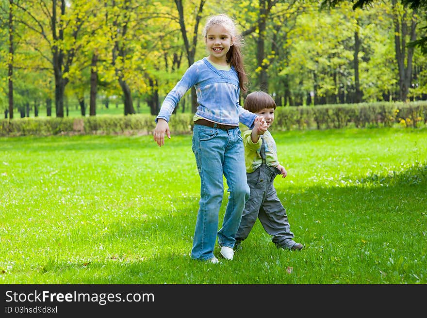 Brother and sister having fun in a park