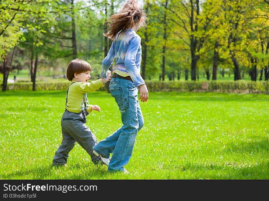 Brother and sister having fun in a park