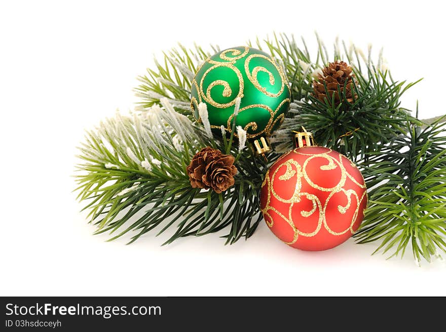 Christmas balls against the backdrop of tinsel with pine branches and cones. Christmas balls against the backdrop of tinsel with pine branches and cones