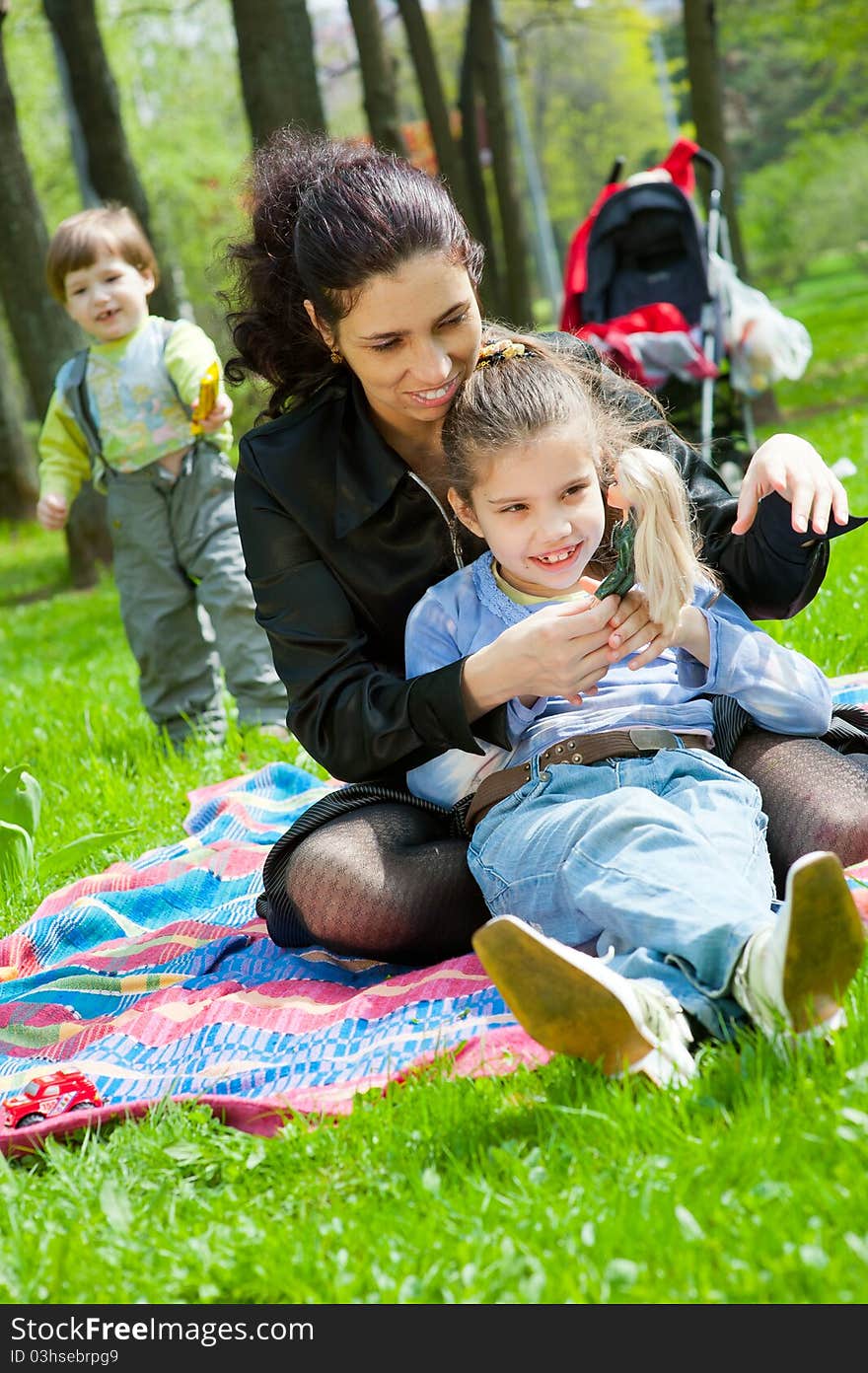 Mother with children resting and playing in the park