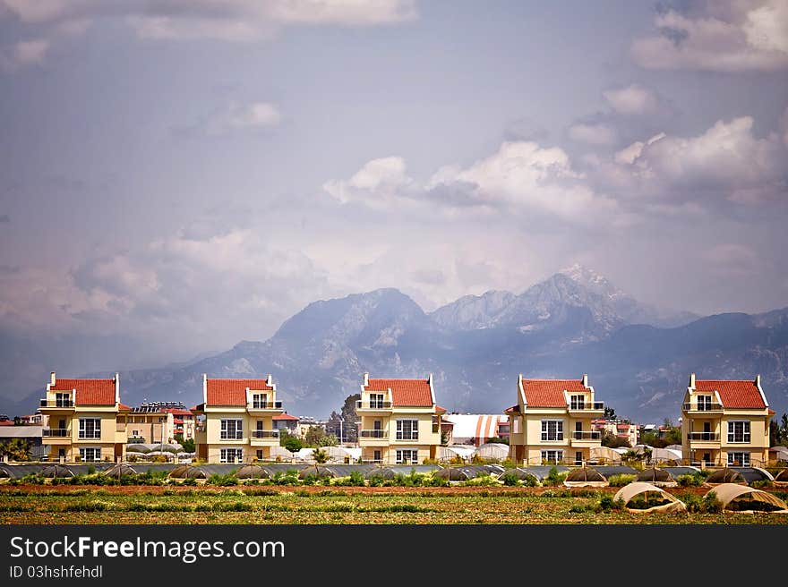 Modern houses in a row, mountains on background