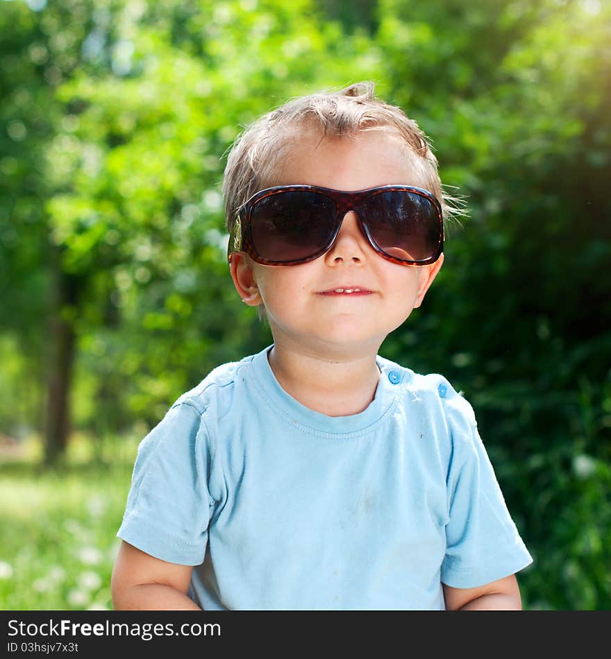 Boy Sunglasses In The Summer Park