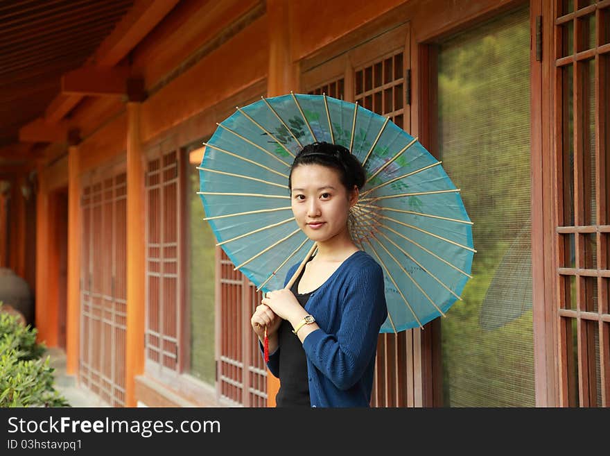 Attractive young woman with an umbrella. Attractive young woman with an umbrella