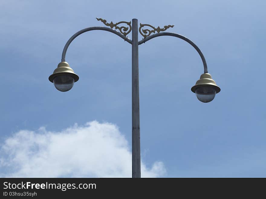 Big streetlamp against  blue  sky. Big streetlamp against  blue  sky