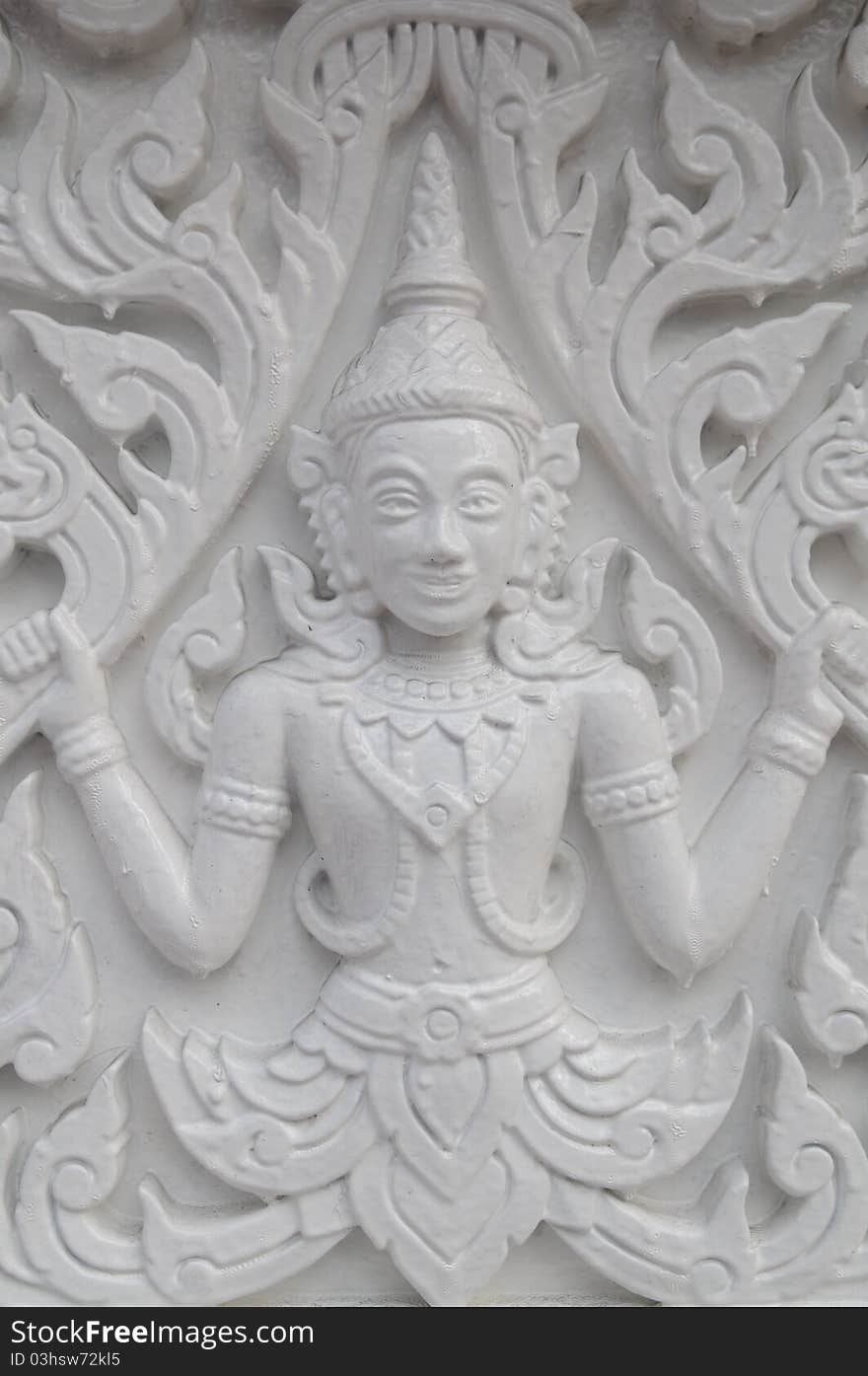 Details of traditional Thai art on base of church.