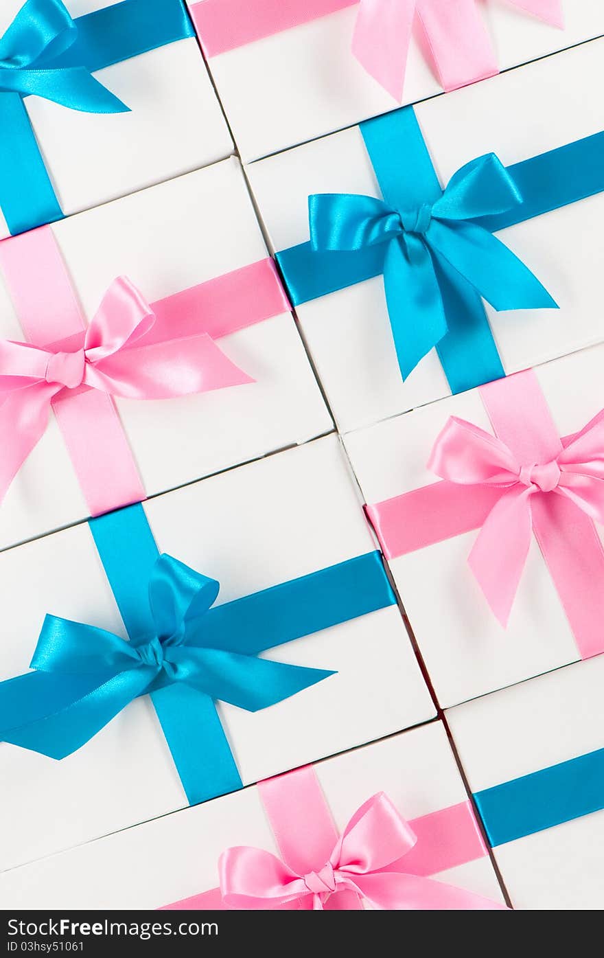 Boxes with pink and blue ribbons on white. Boxes with pink and blue ribbons on white