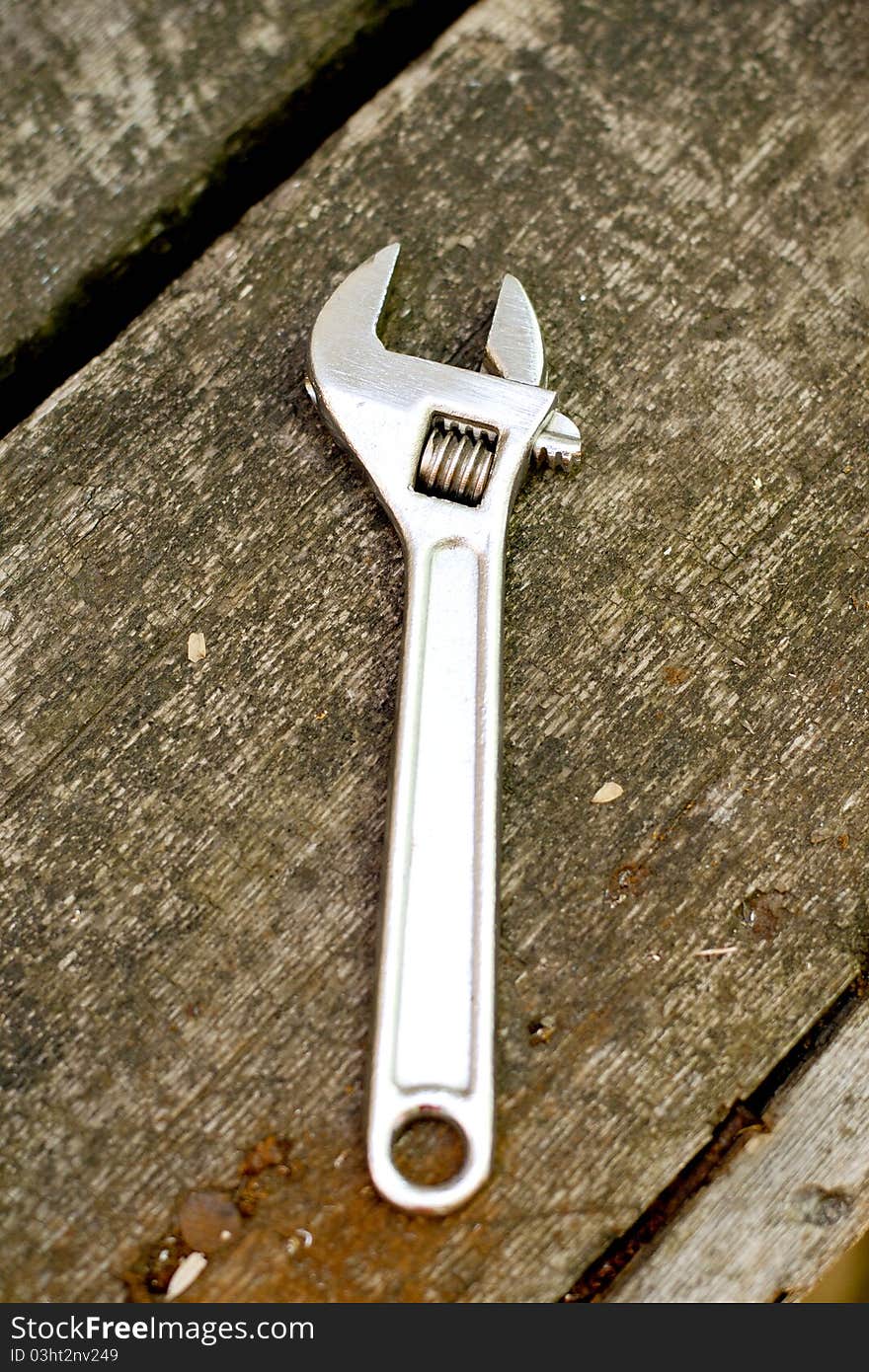 Wrench on a background an old wooden table