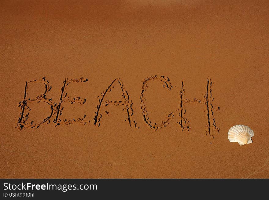 The word beach on sand